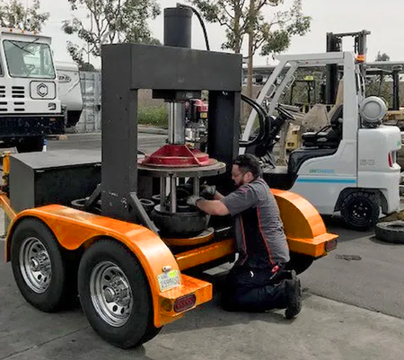 Technician using Quantum Lift Forklift mobile tire press